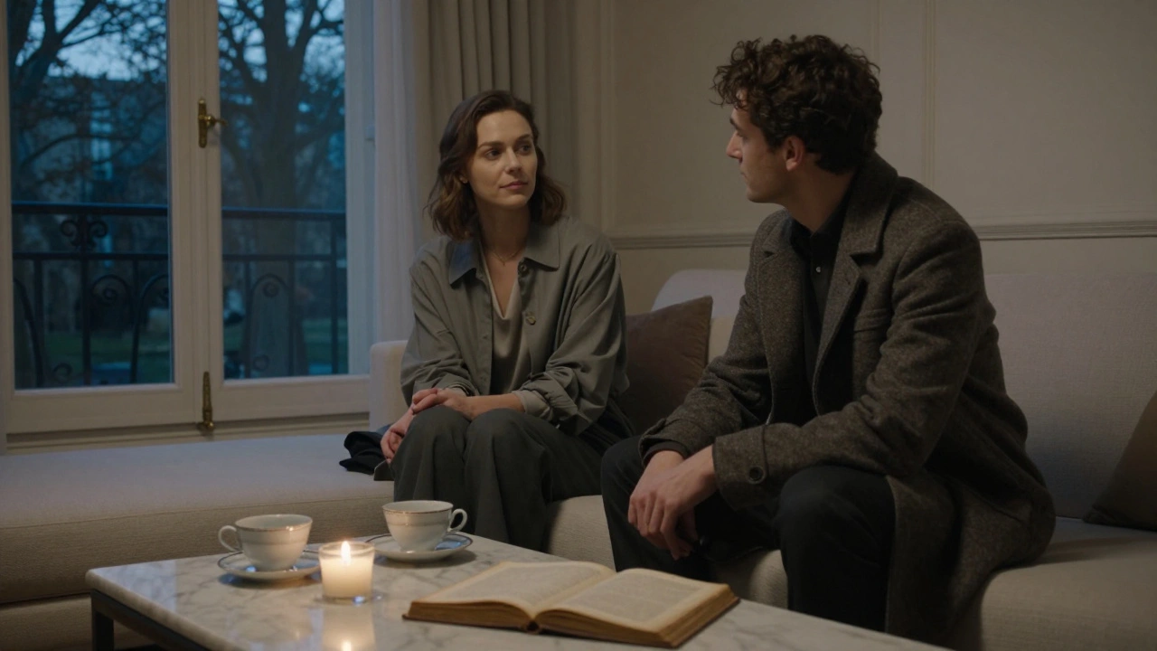 Two people sit in quiet conversation in a luxurious Paris apartment at dusk, candlelight glowing softly.
