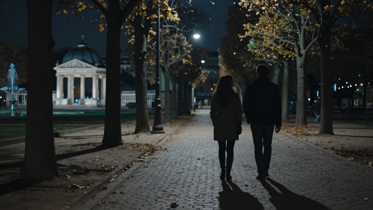 Silhouettes of two individuals walking peacefully through Parc Monceau at night under soft streetlights and falling autumn leaves.