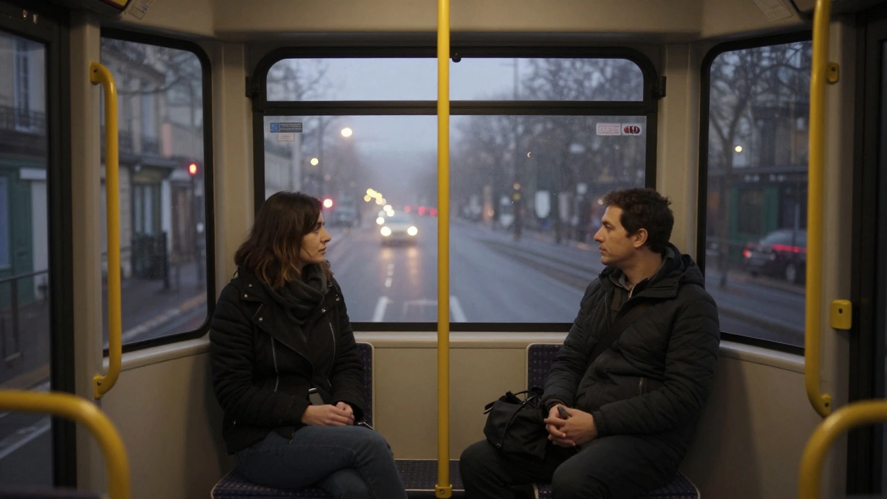 Two individuals on a late-night Paris tram, passing quiet neighborhood streets through a fogged window.